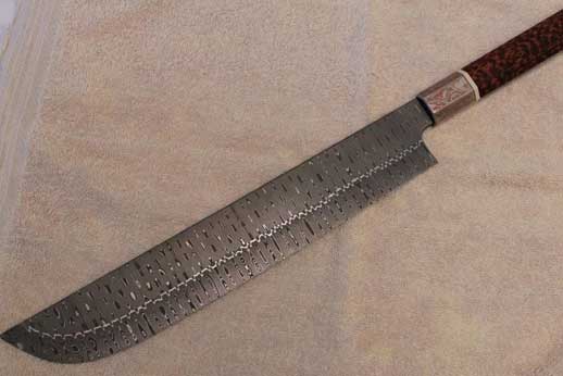 Backside of knife. Snakewood and mokume handle. Stainless composite damascus blade. 330mm blade length. 